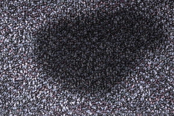 Dark stain on gray carpet
